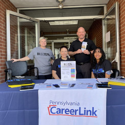 Four people at a table for Community Outreach at the PA CareerLink® office in Hazleton