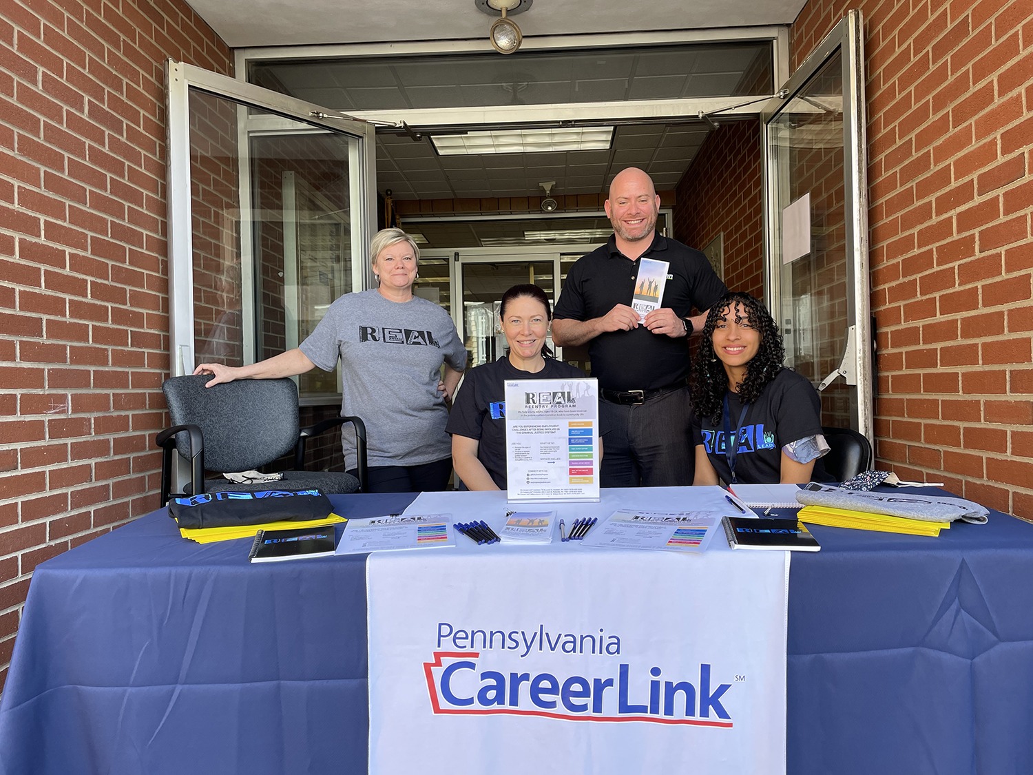 Four people at a table for Community Outreach at the PA CareerLink® office in Hazleton
